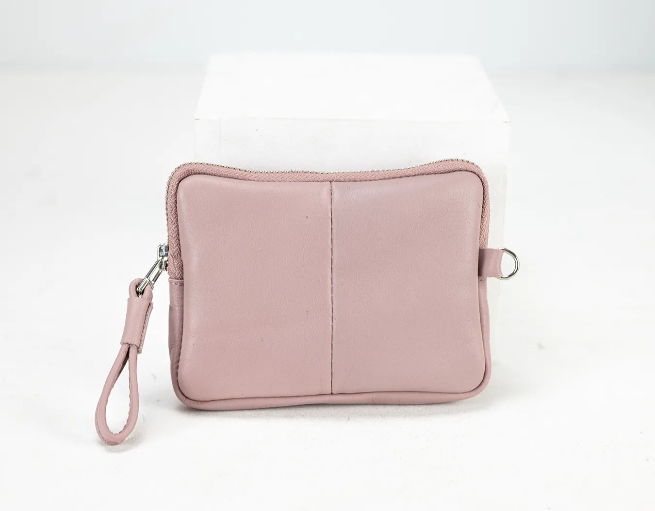 Pink pouch with a strap on a white background
