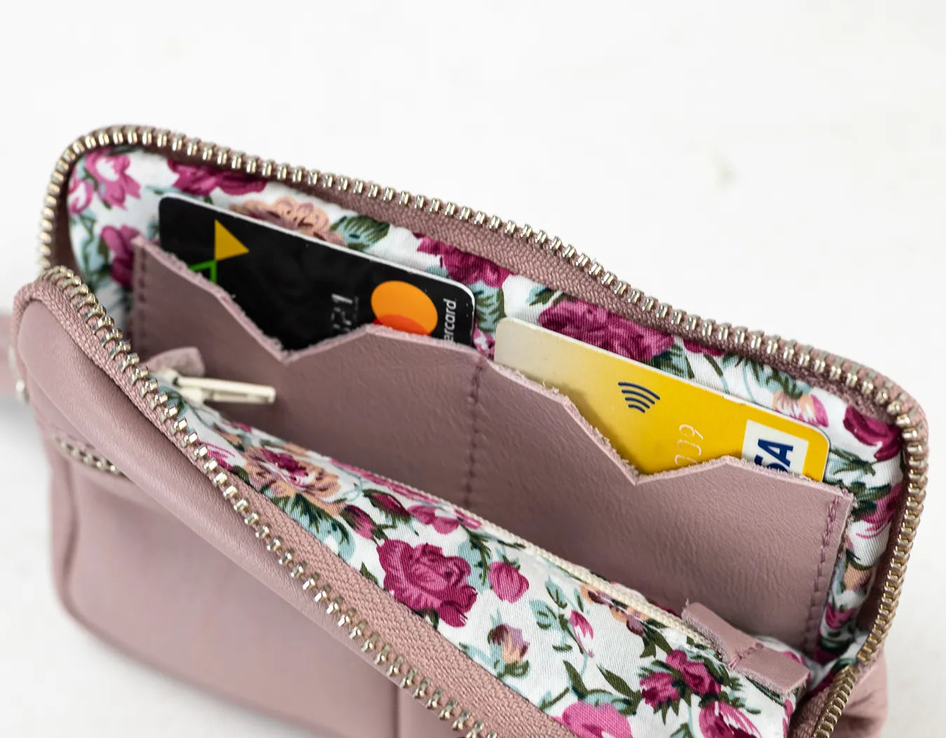 Floral-patterned wallet with cards inside on a white background