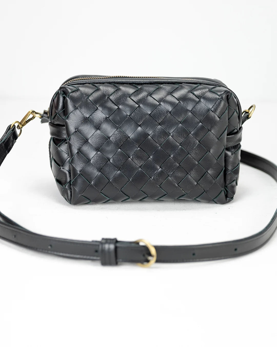 Black woven handbag with a strap on a white background