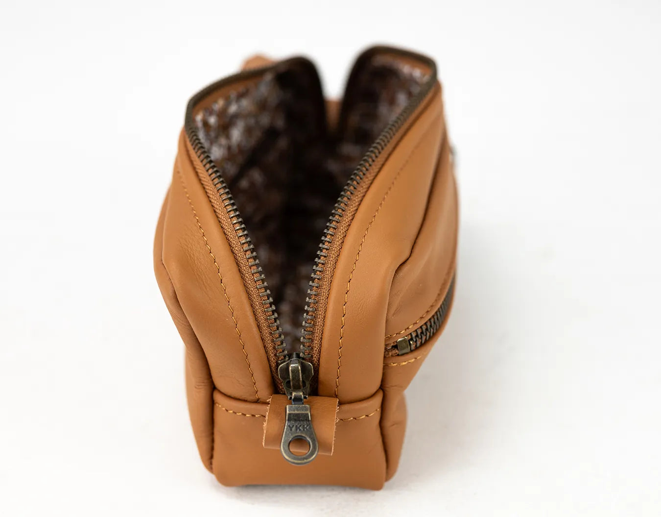 Brown leather zippered pouch with a white background