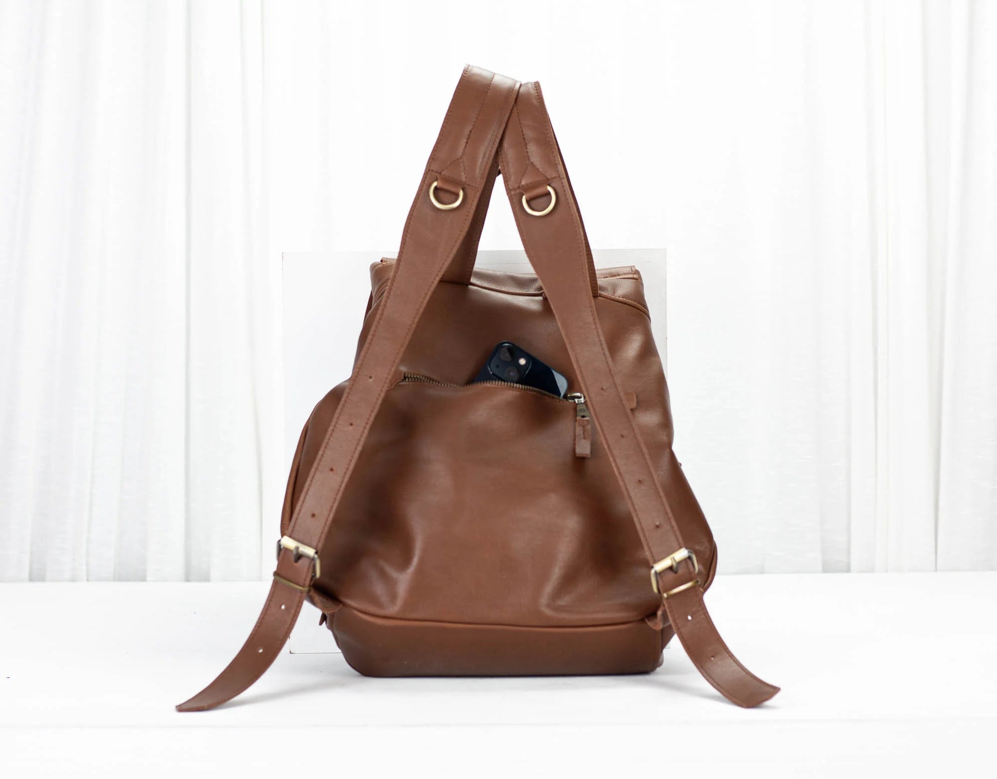 Brown leather backpack on a white background