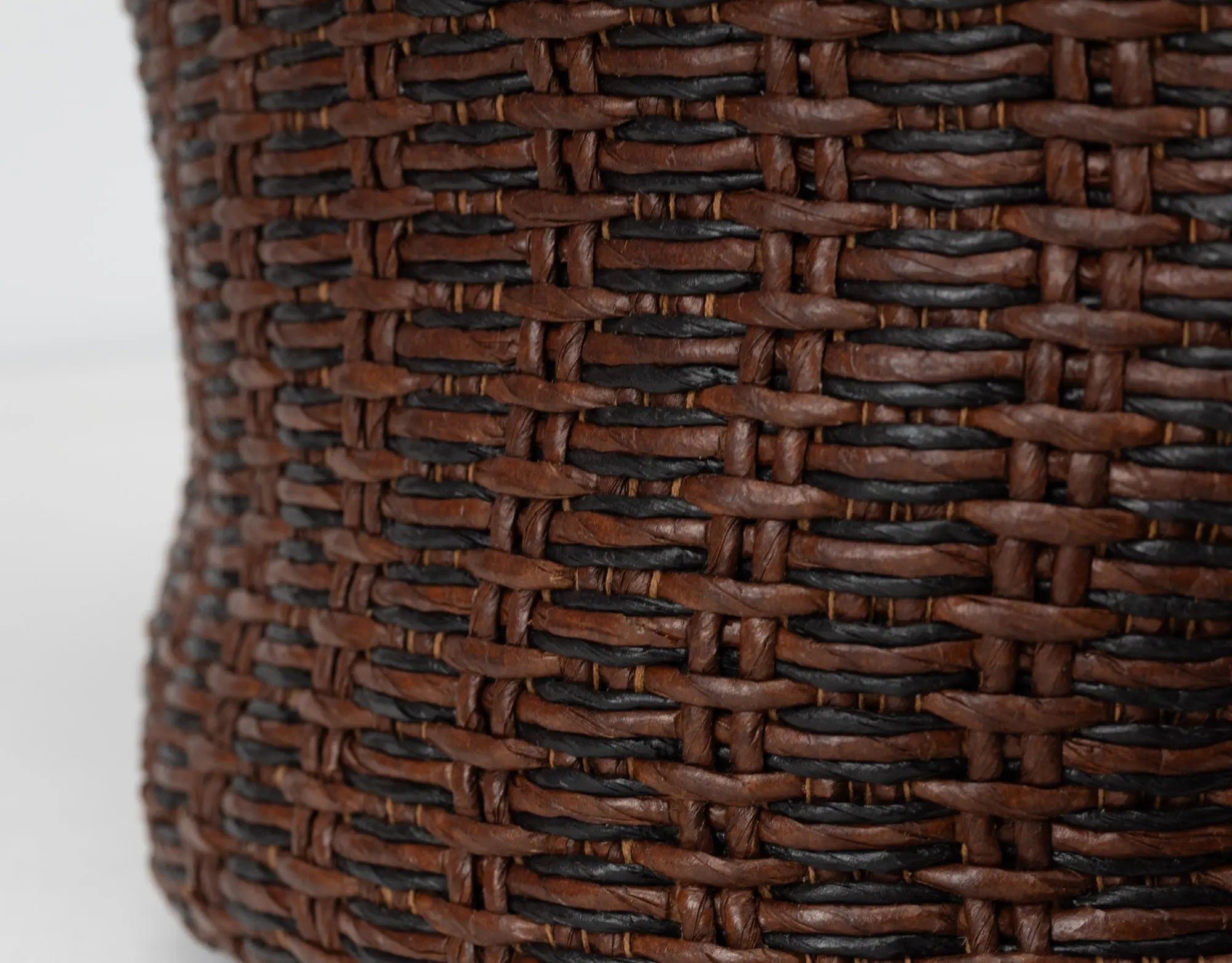 Close-up of a brown woven basket on a white background