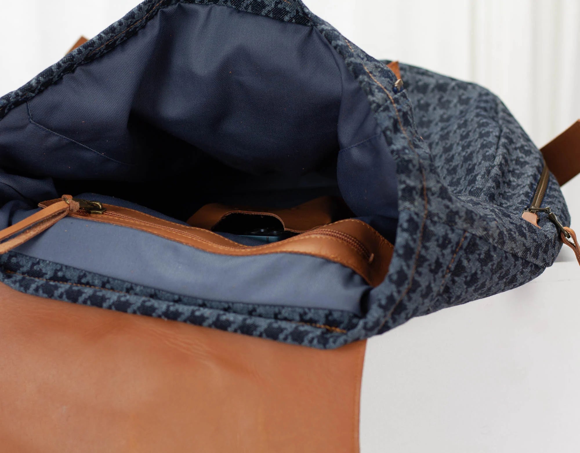 Close-up of a blue and brown bag with a patterned top section.