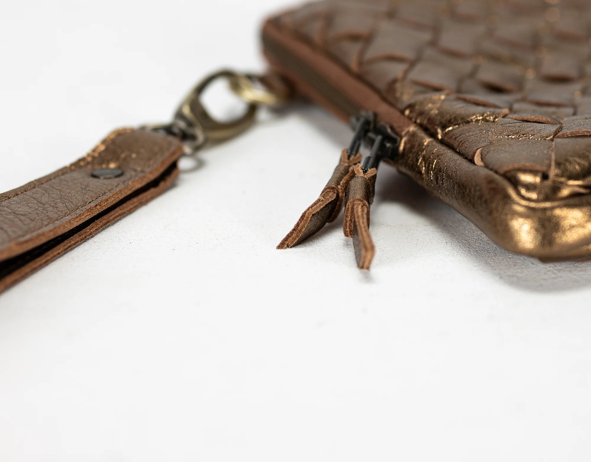 Brown leather wallet with keychain on a white background