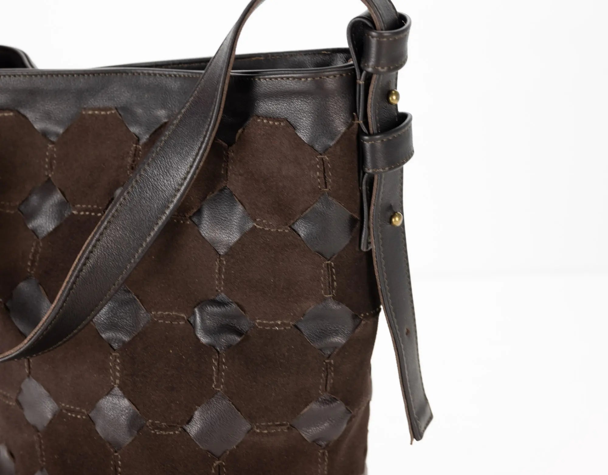 Brown textured handbag with a strap on a white background