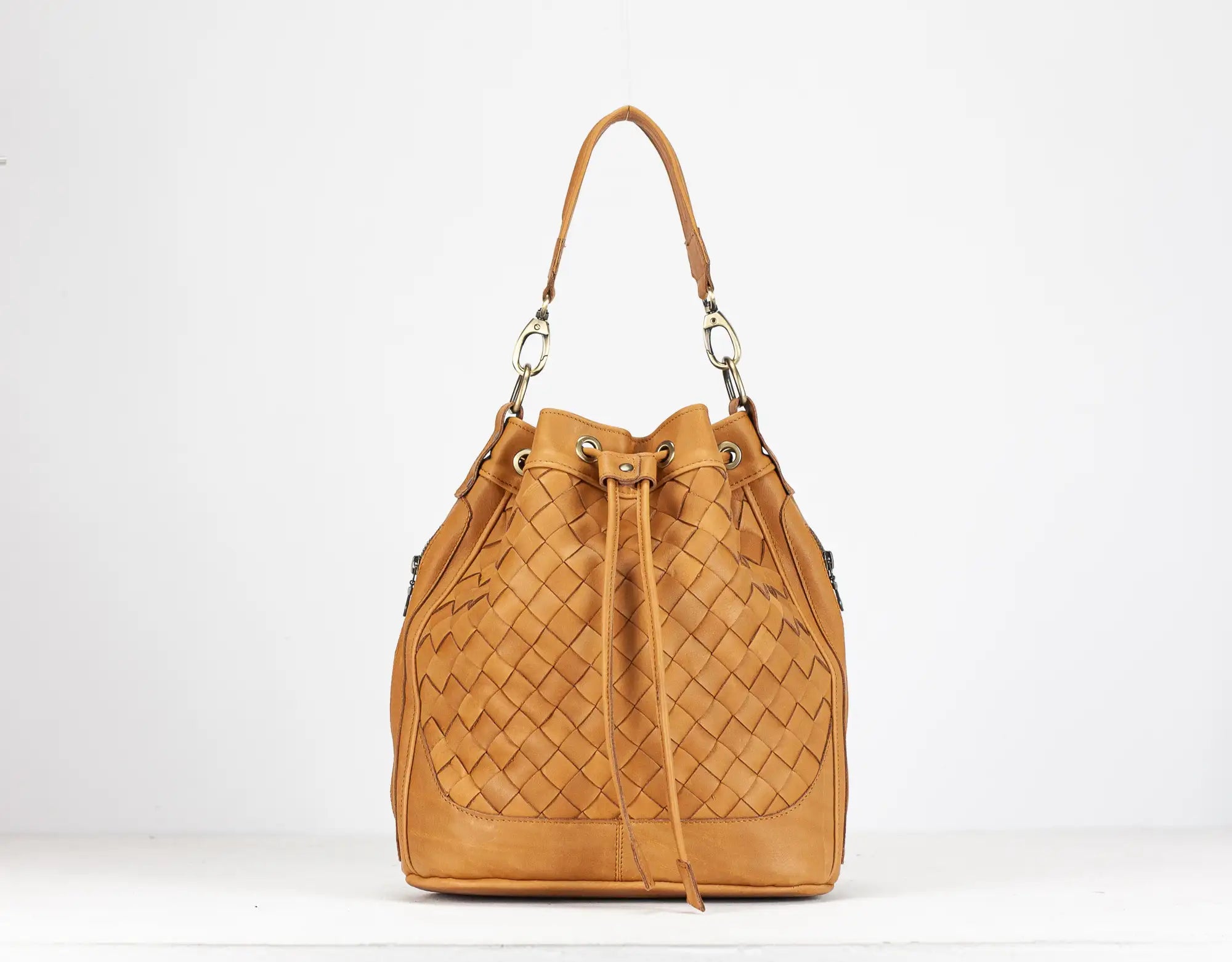 Tan woven handbag on a white background