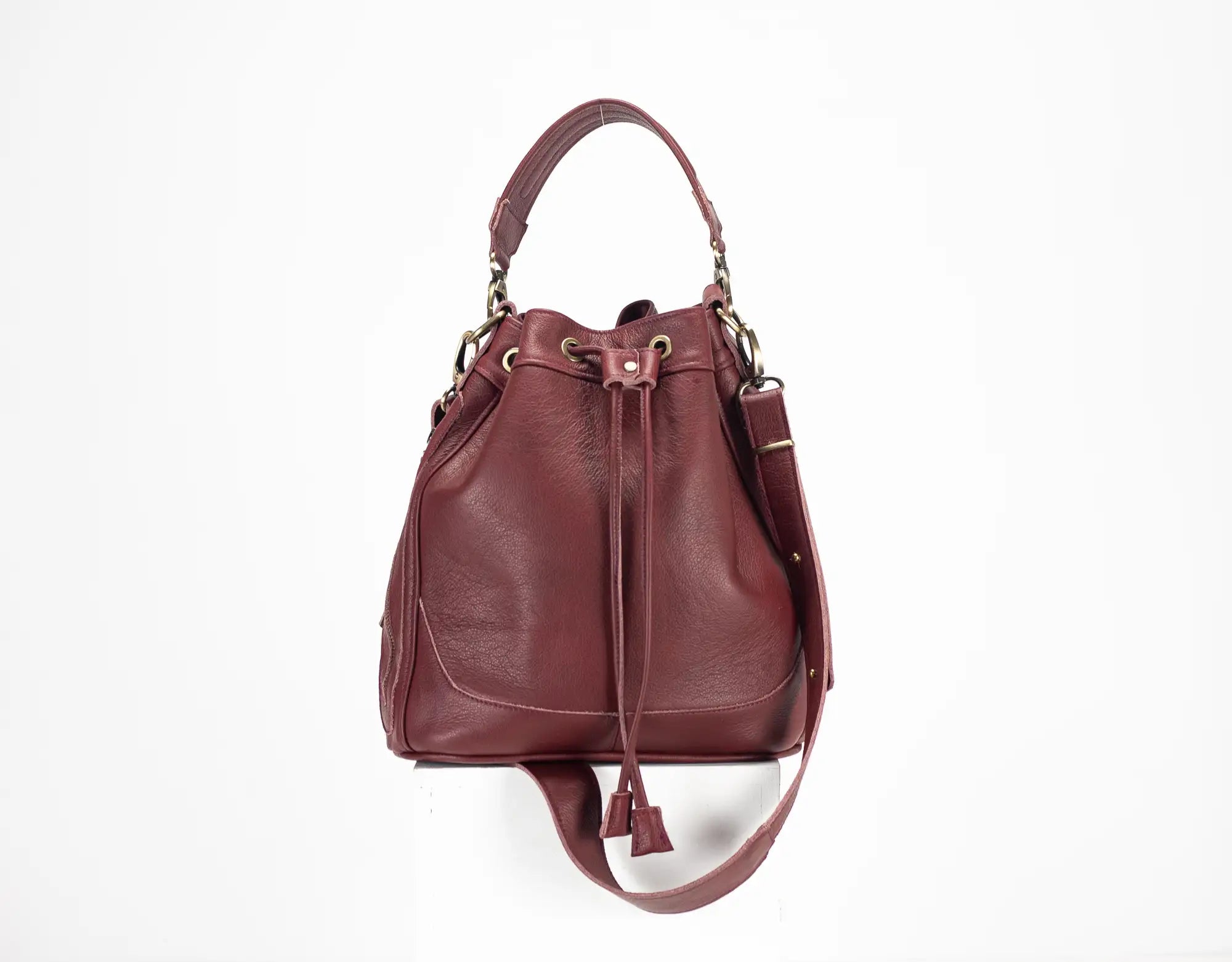 Burgundy leather bucket bag on a white background