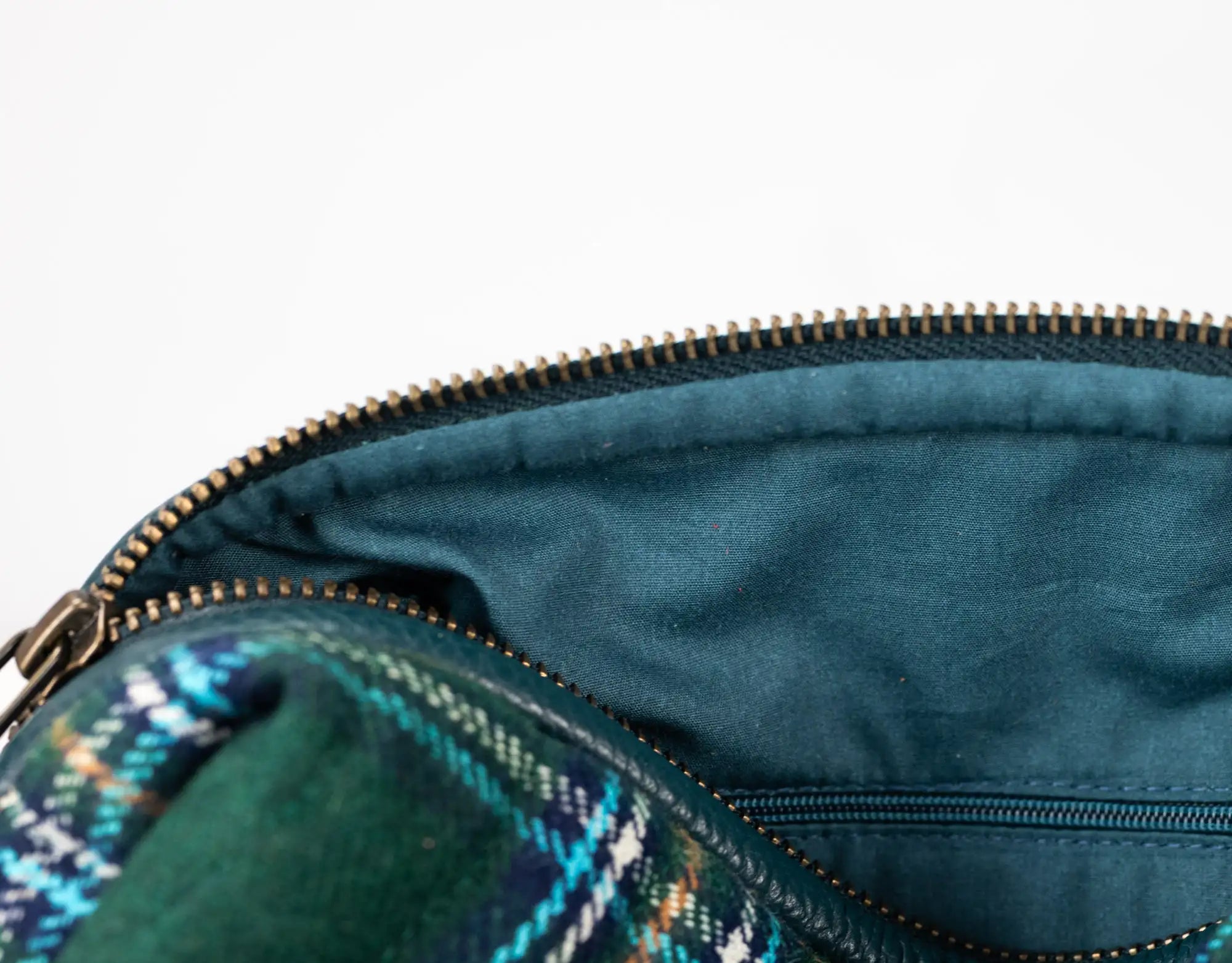 Close-up of a blue bag with a zipper, showing the interior.