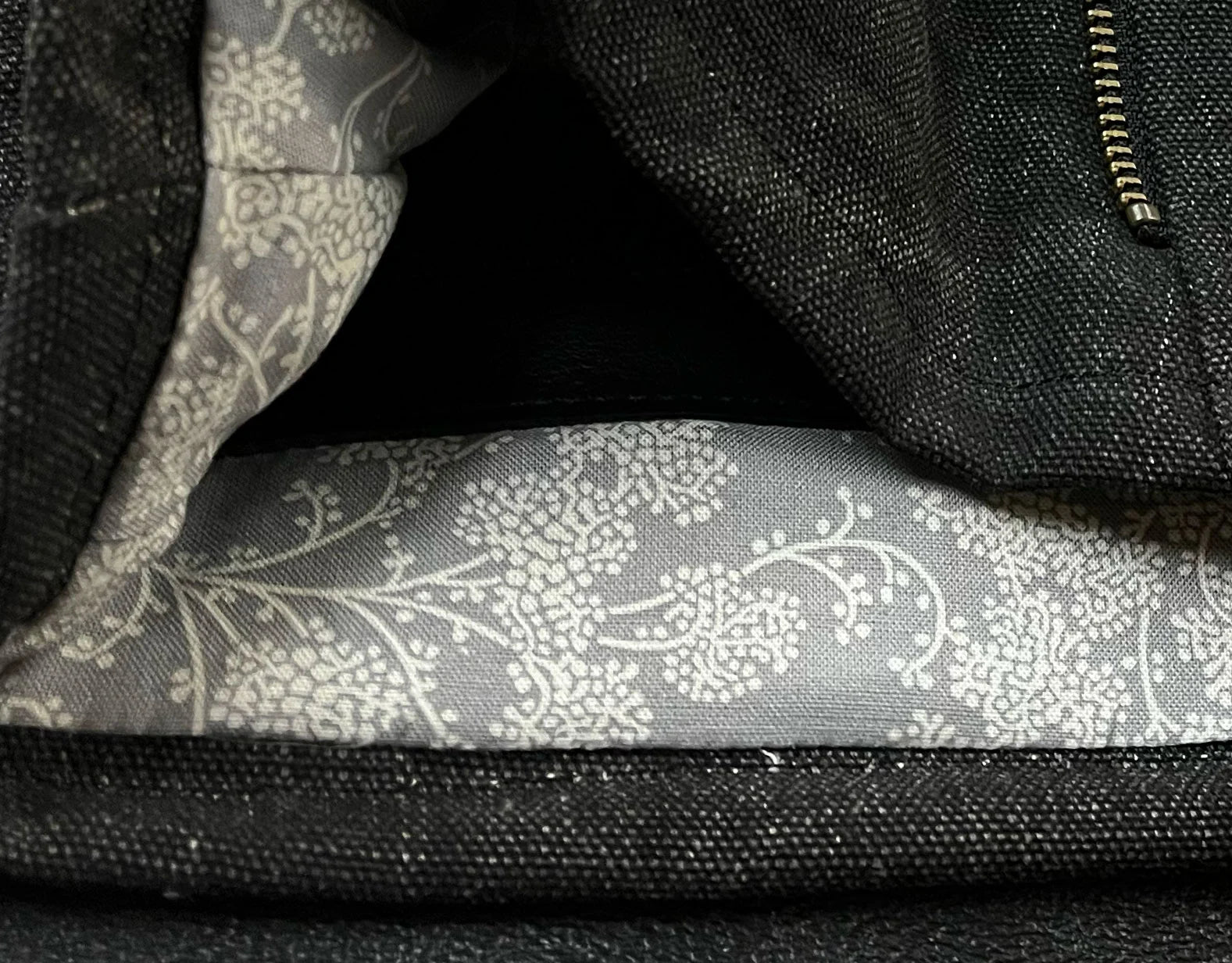 Close-up of a black bag with floral-patterned lining