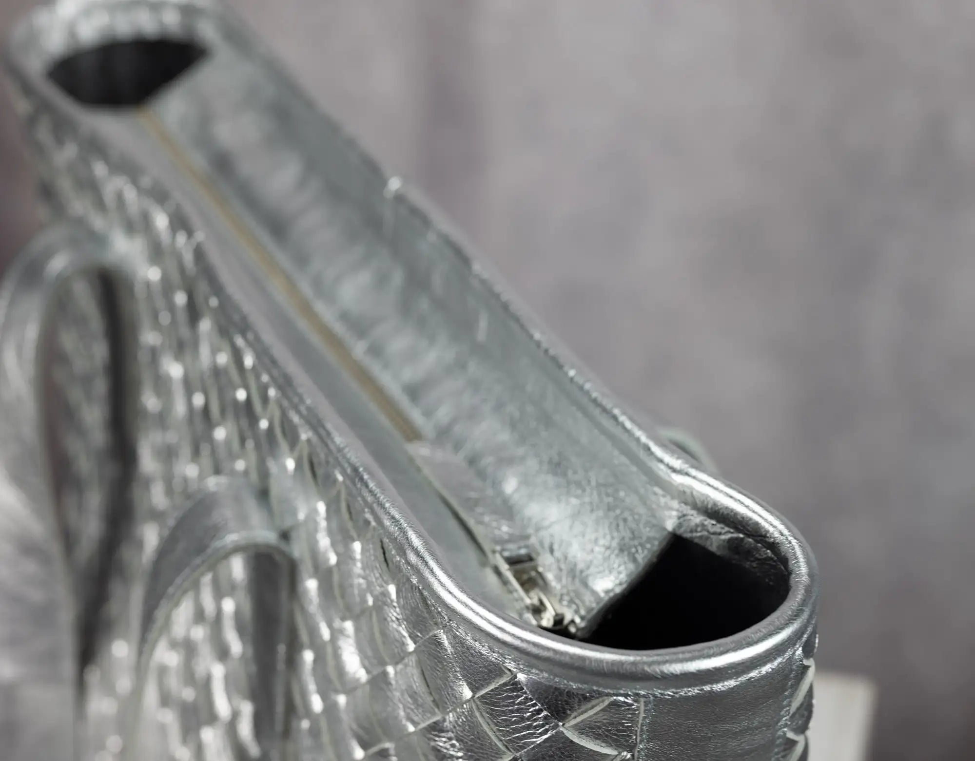 Close-up of a silver clutch with intricate designs