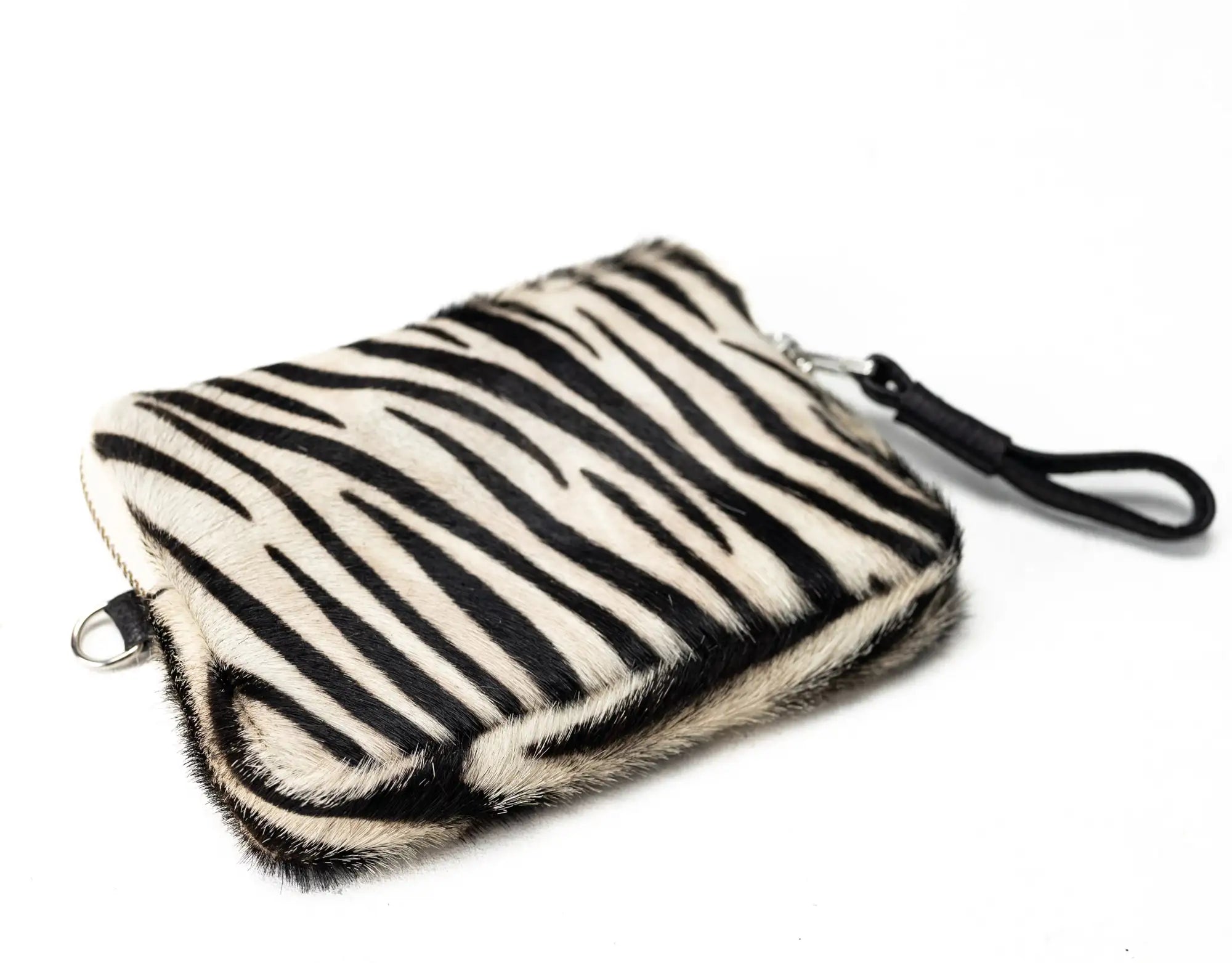 Zebra patterned clutch bag on a white background
