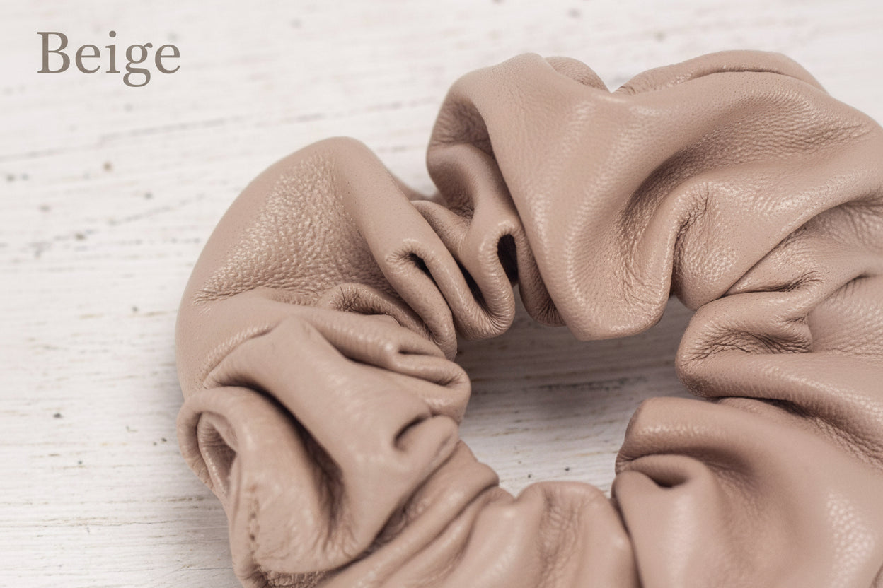 Beige scrunchie on a light wooden surface