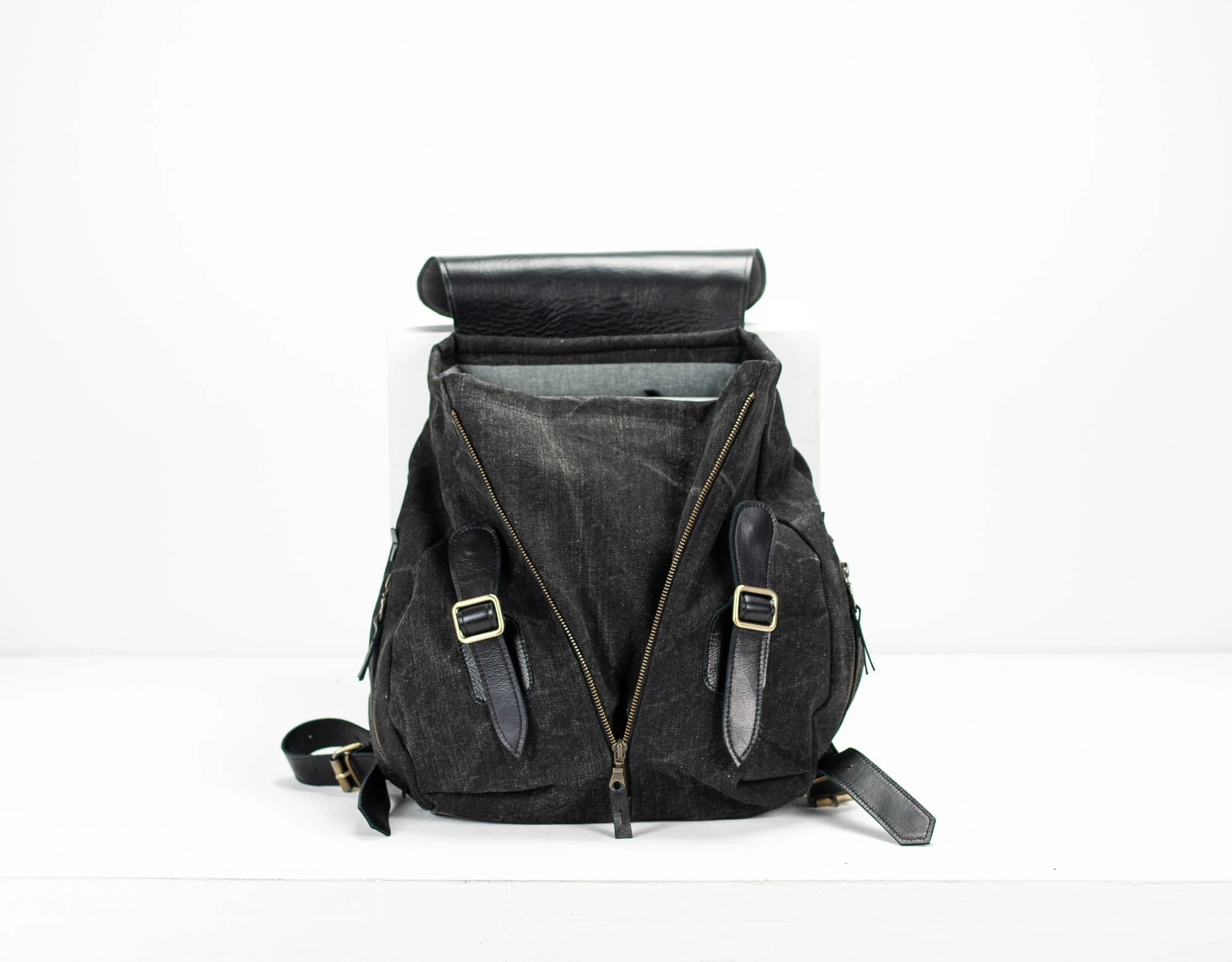 Black backpack with straps on a white background