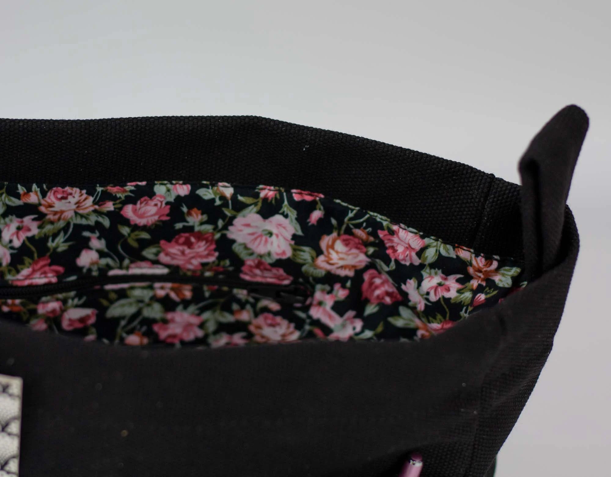 Black bag with floral lining on a white background