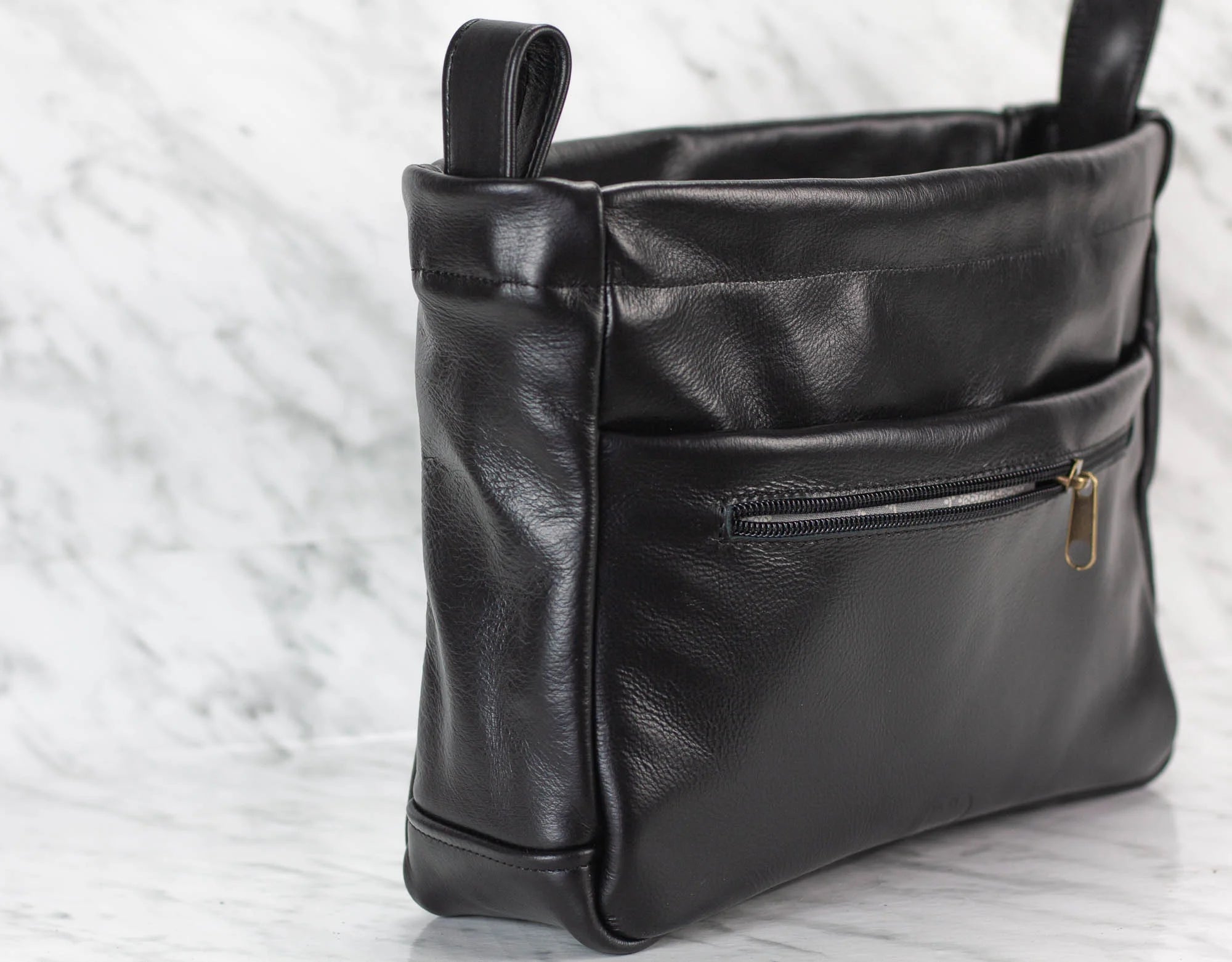 Black leather purse insert with a zipper on a light background