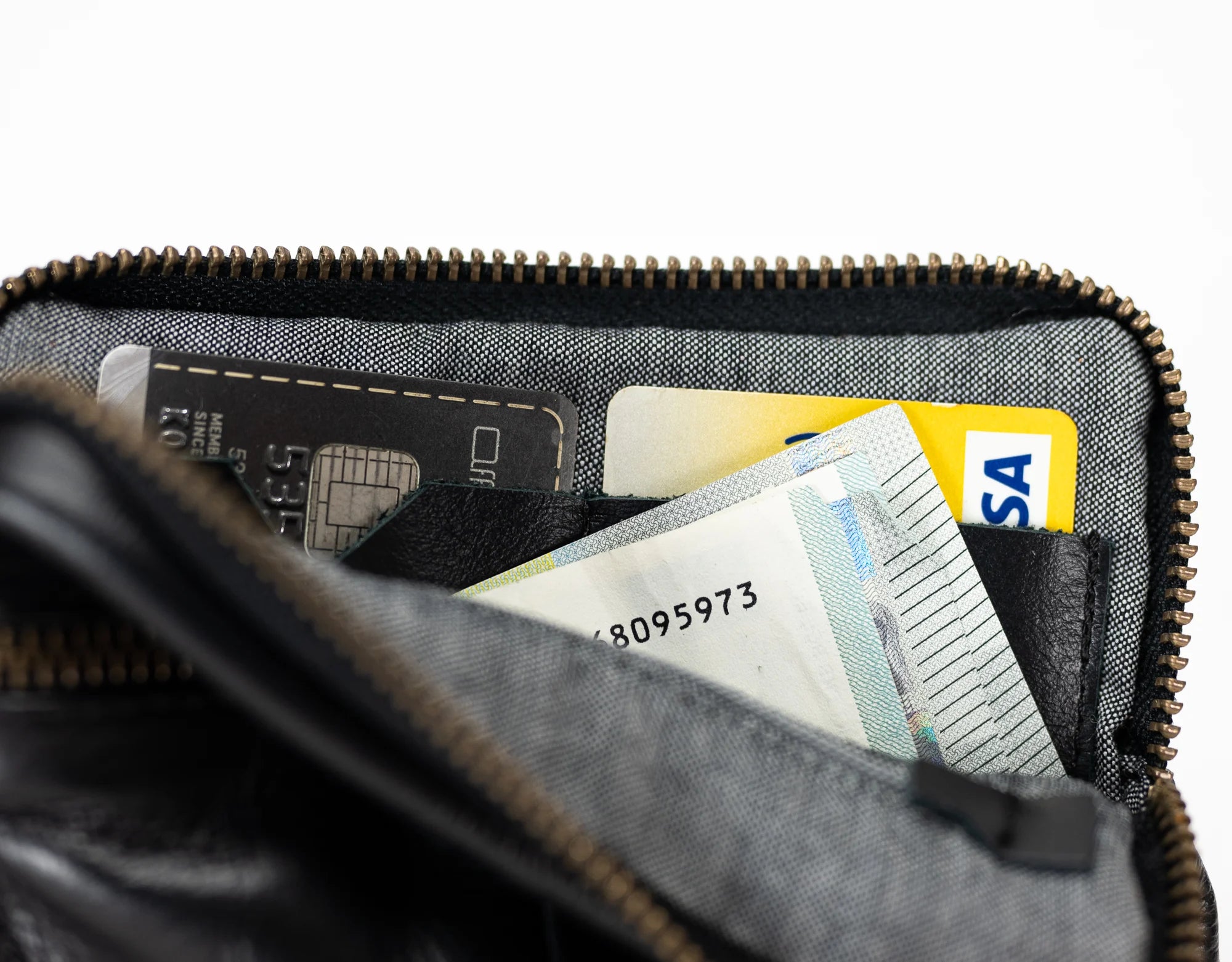 Close-up of a wallet with various cards inside on a white background