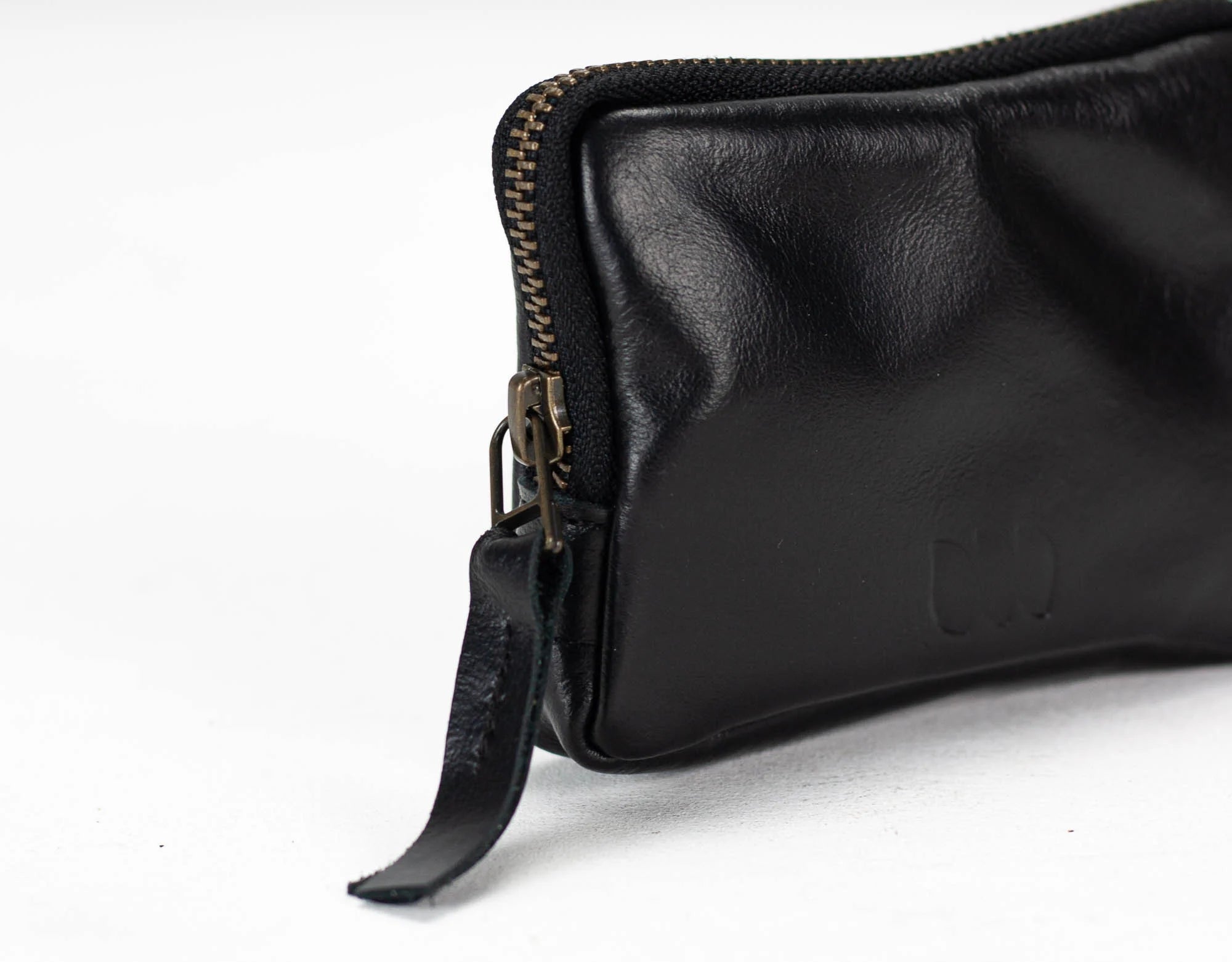 Black leather pouch with zipper on a white background