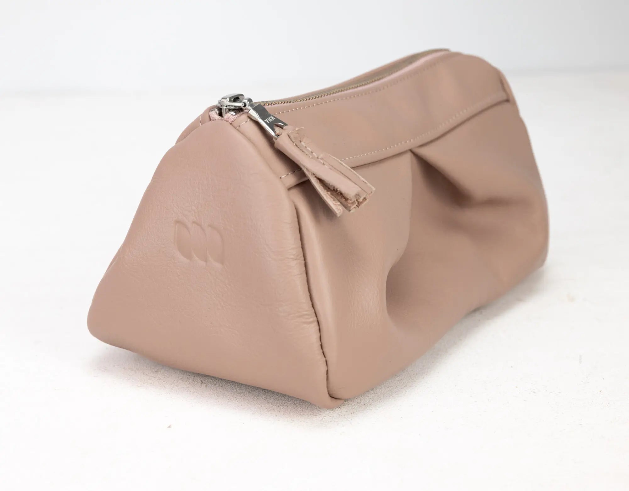 Beige handbag with a visible brand logo on a white background