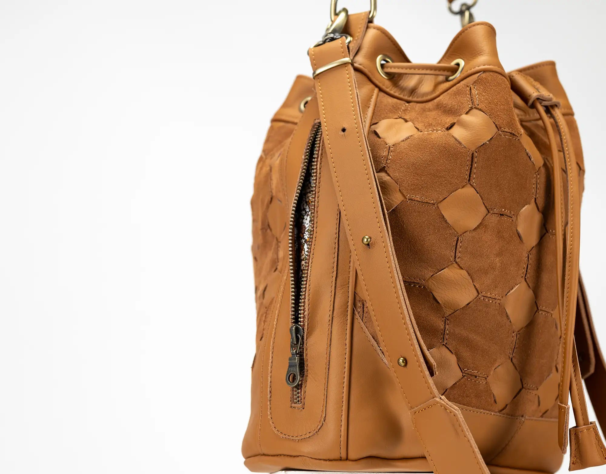 Brown leather backpack with geometric pattern on a white background