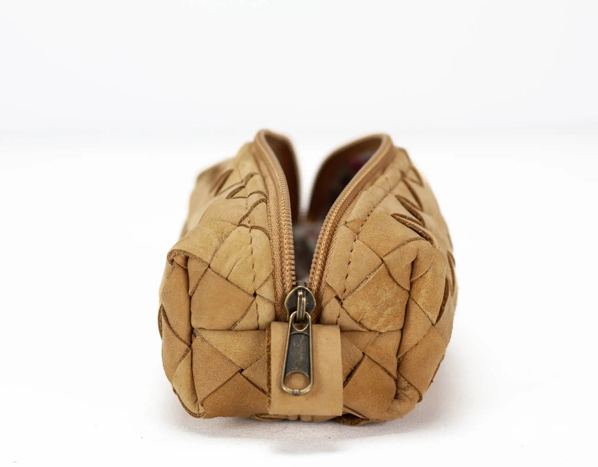 Quilted beige handbag with a zipper on a white background