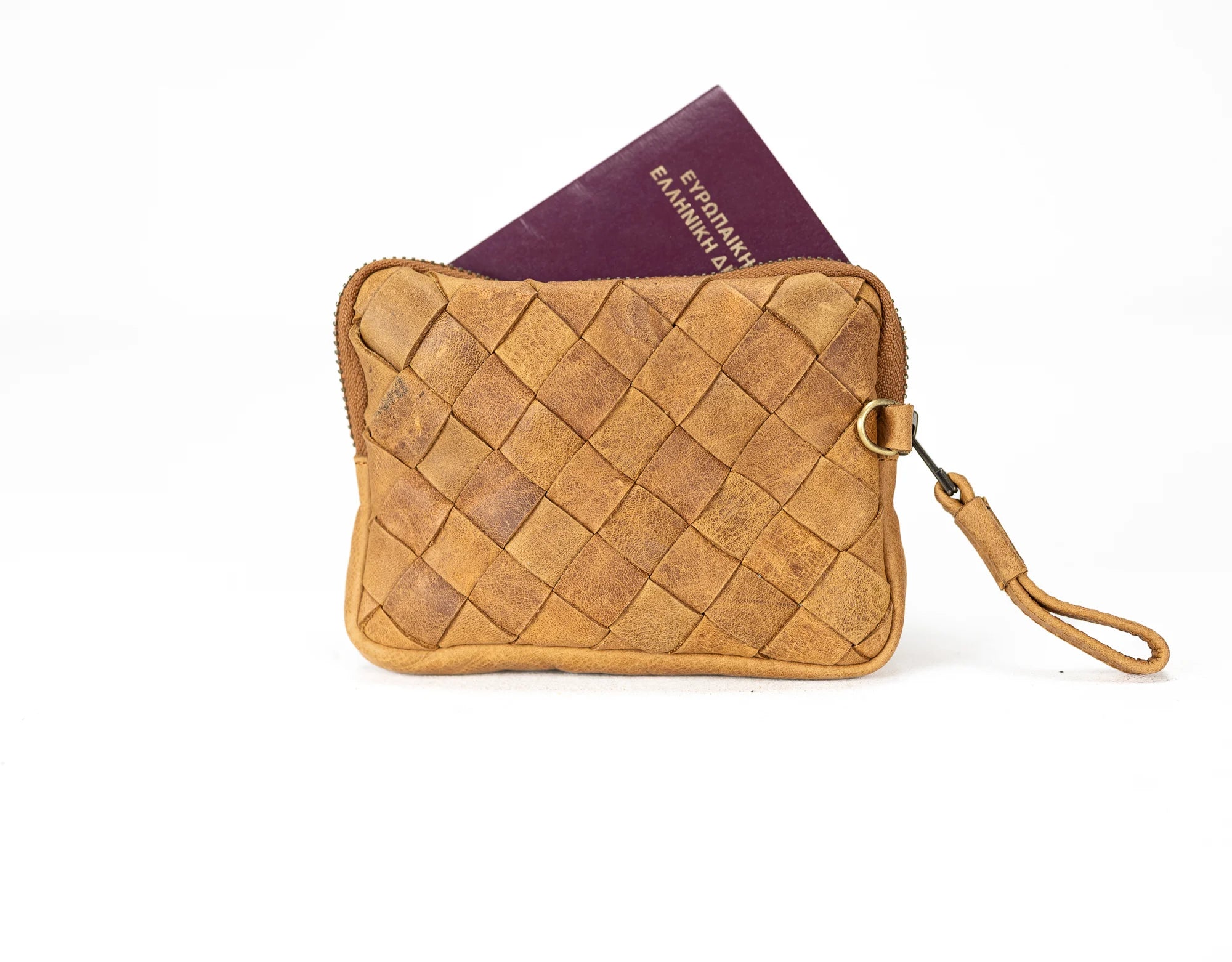 Brown woven leather pouch with a passport on a white background