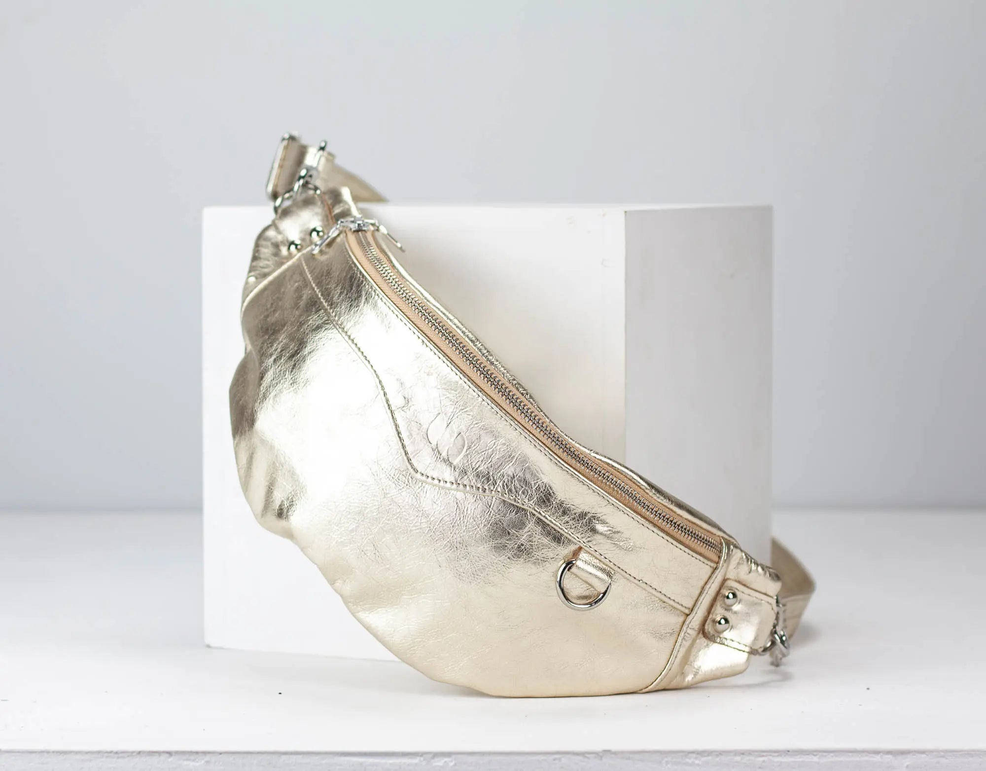 Gold metallic fanny pack on a white background
