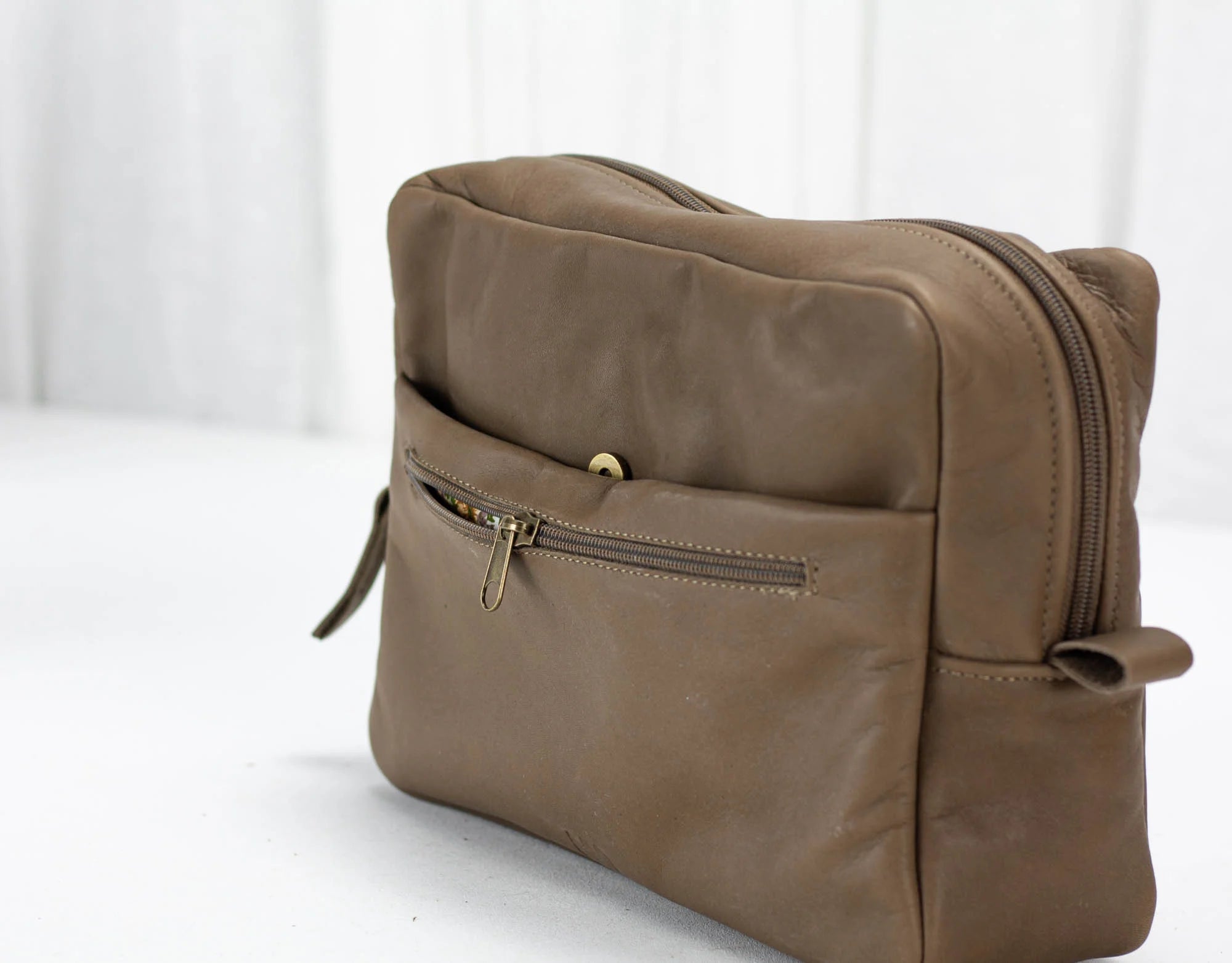 khaki Brown leather clutch bag with a zipper on a white background