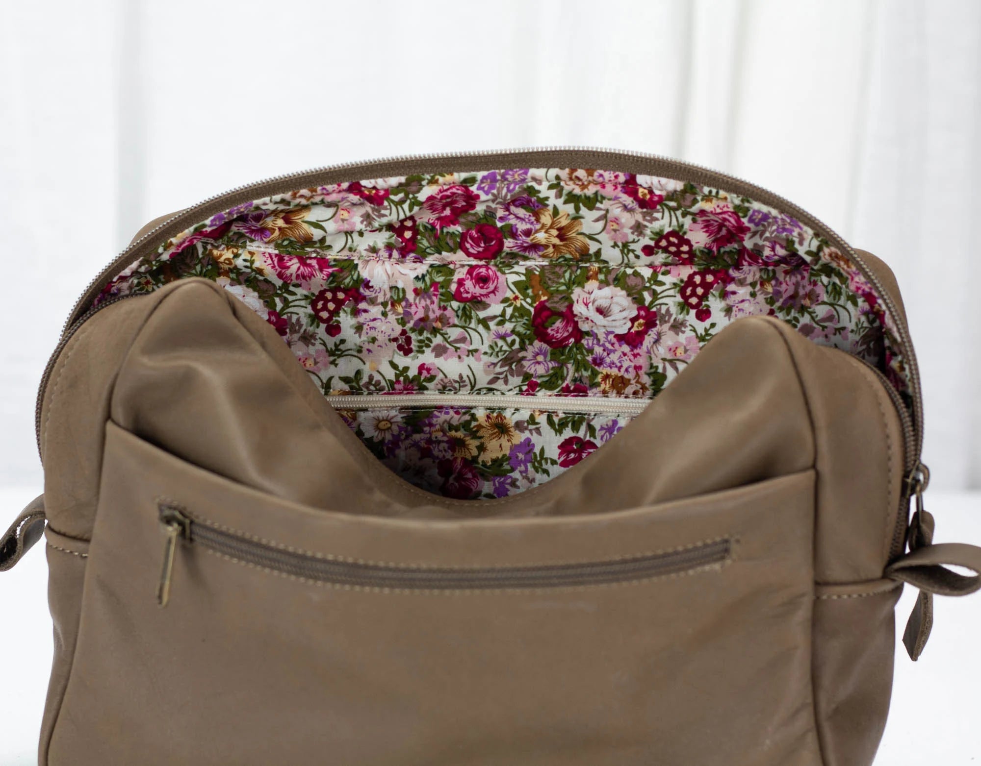 khaki Brown bag with floral lining on a white background