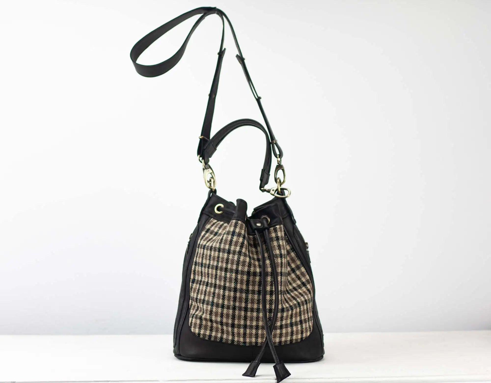 Black and plaid drawstring bag on a white background