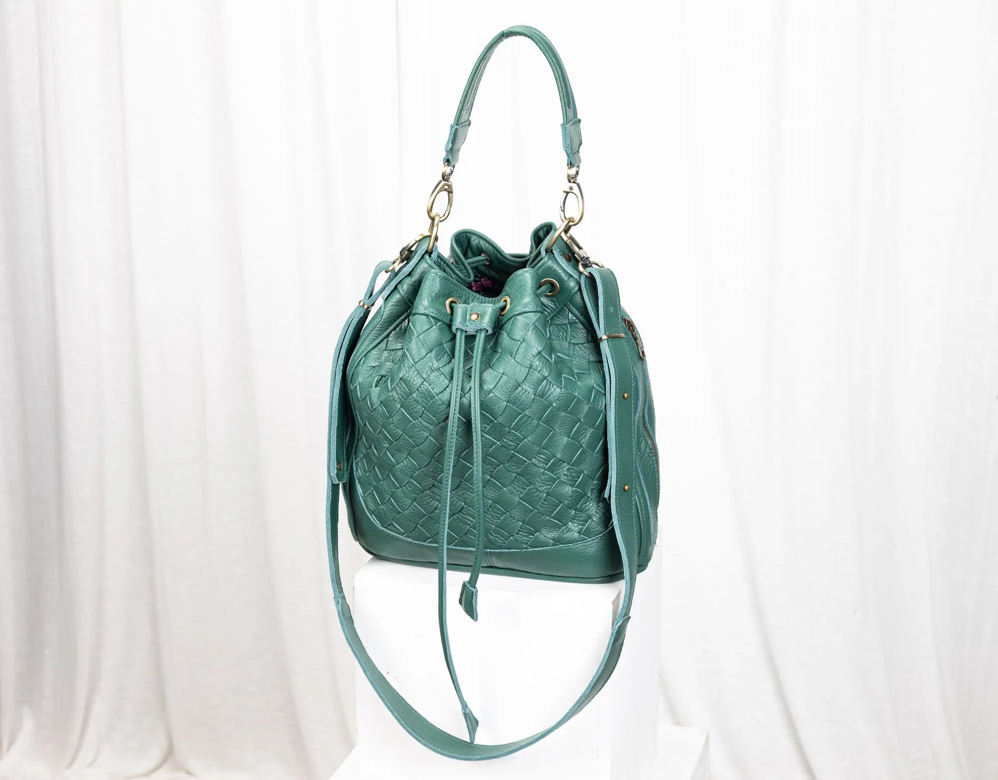 Green textured handbag on a white background