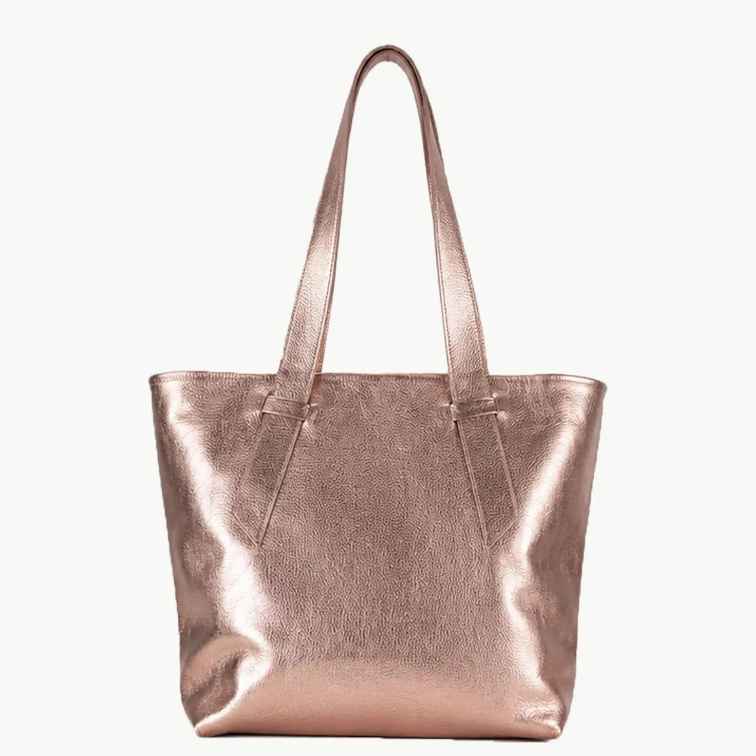 A metallic rose gold leather tote bag with two shoulder straps, shown against a plain off-white background.