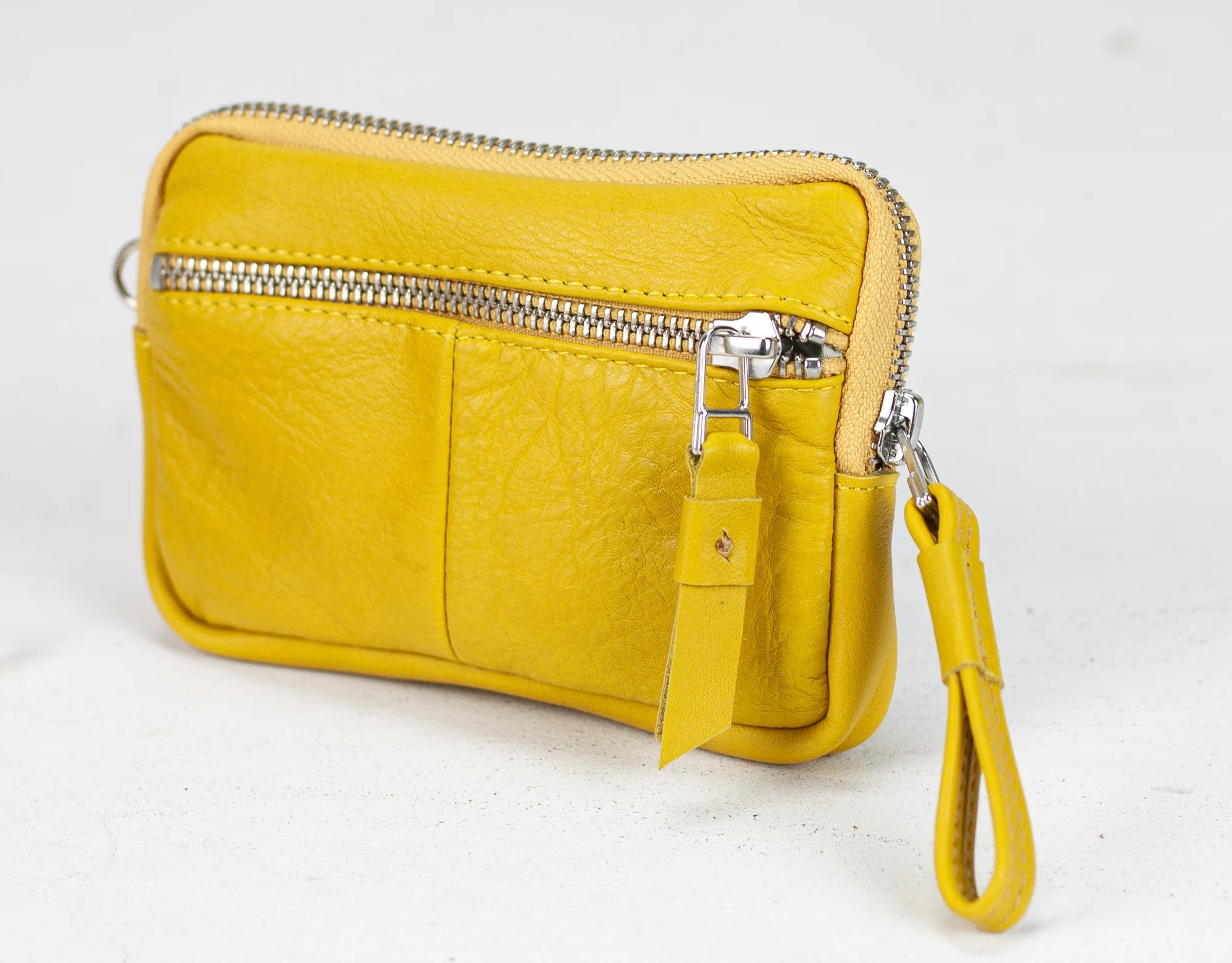 Yellow leather wallet with card slots on a white background
