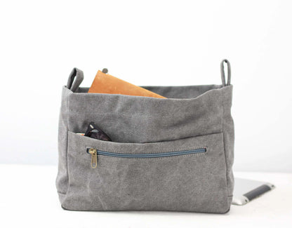Gray fabric bag with a zipper pocket on a white background