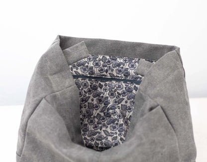 Gray fabric with a floral patterned pocket on a white background