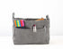 Gray fabric bag insert with colorful markers and clothespins on a white background