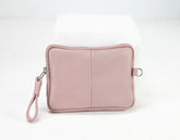 Pink pouch with a strap on a white background