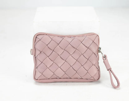 Pink quilted clutch bag with a strap on a white background