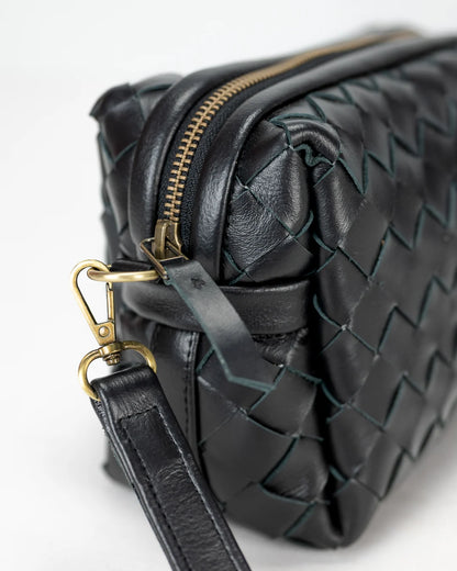 Black woven leather handbag with gold zipper and clasp on a white background