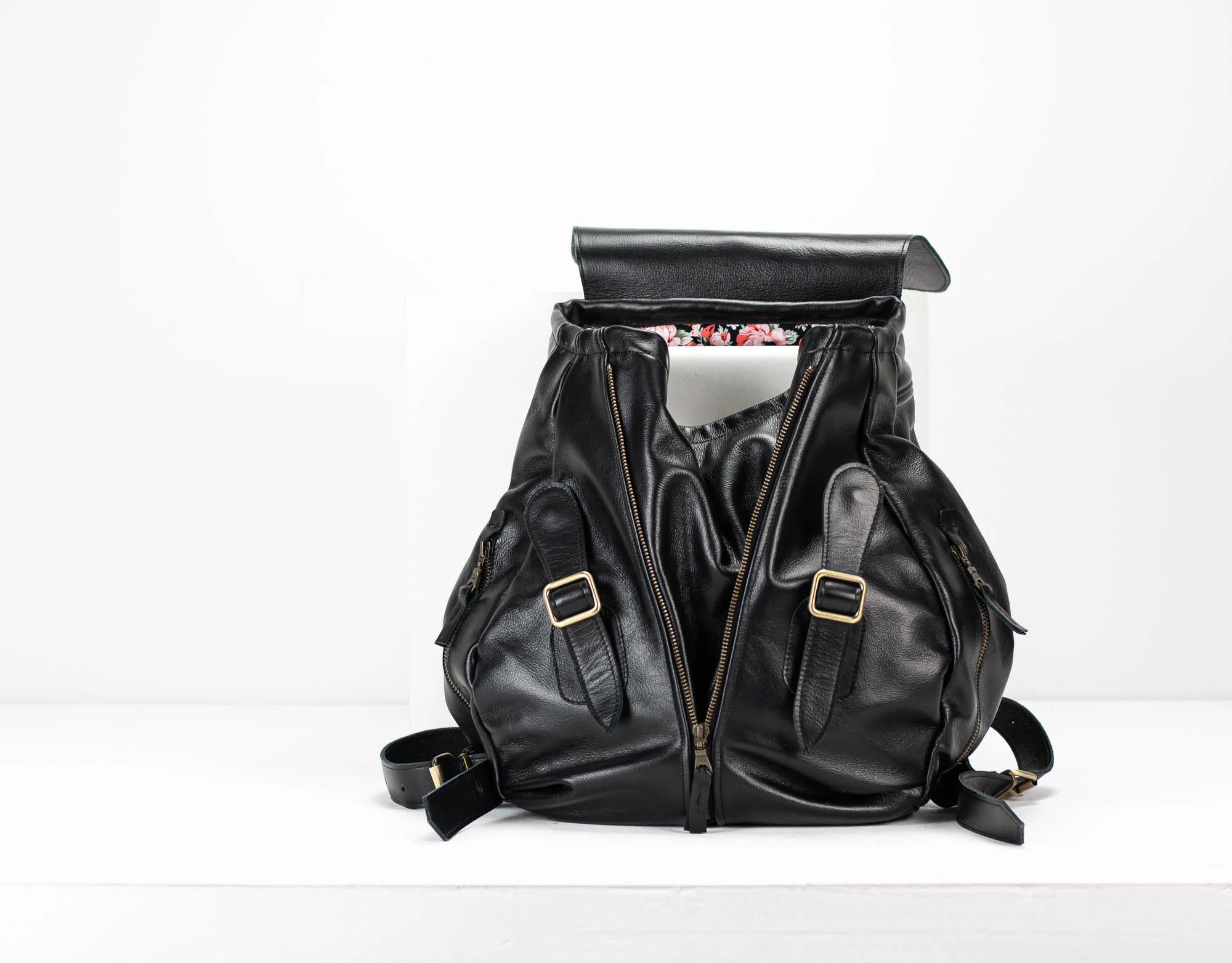 Black leather backpack on a white background