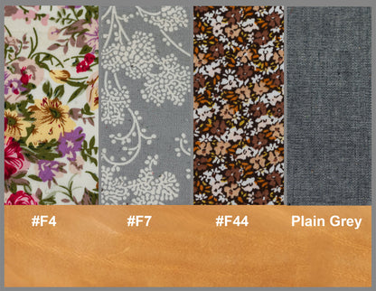 Fabric swatches with floral, patterned, and plain designs on a brown bar with color codes and text.