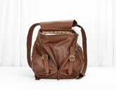 Brown leather backpack on a white background
