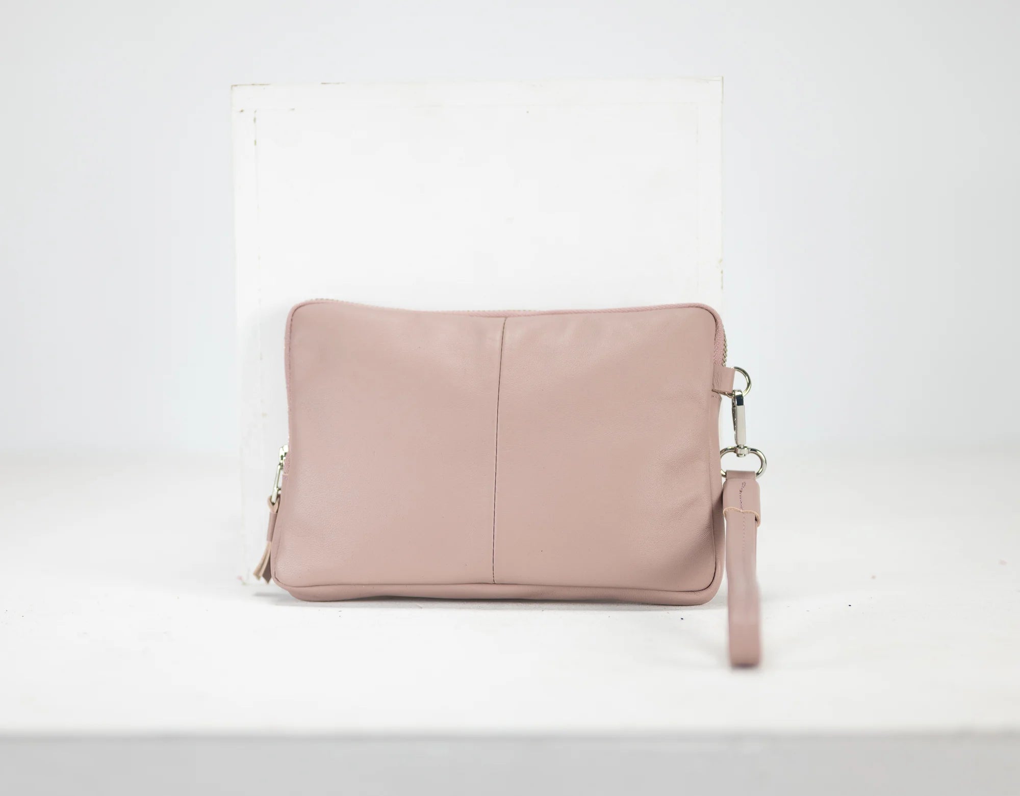 Pink leather clutch bag on a white background