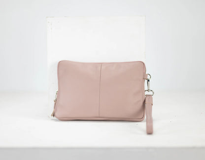 Pink leather clutch bag on a white background