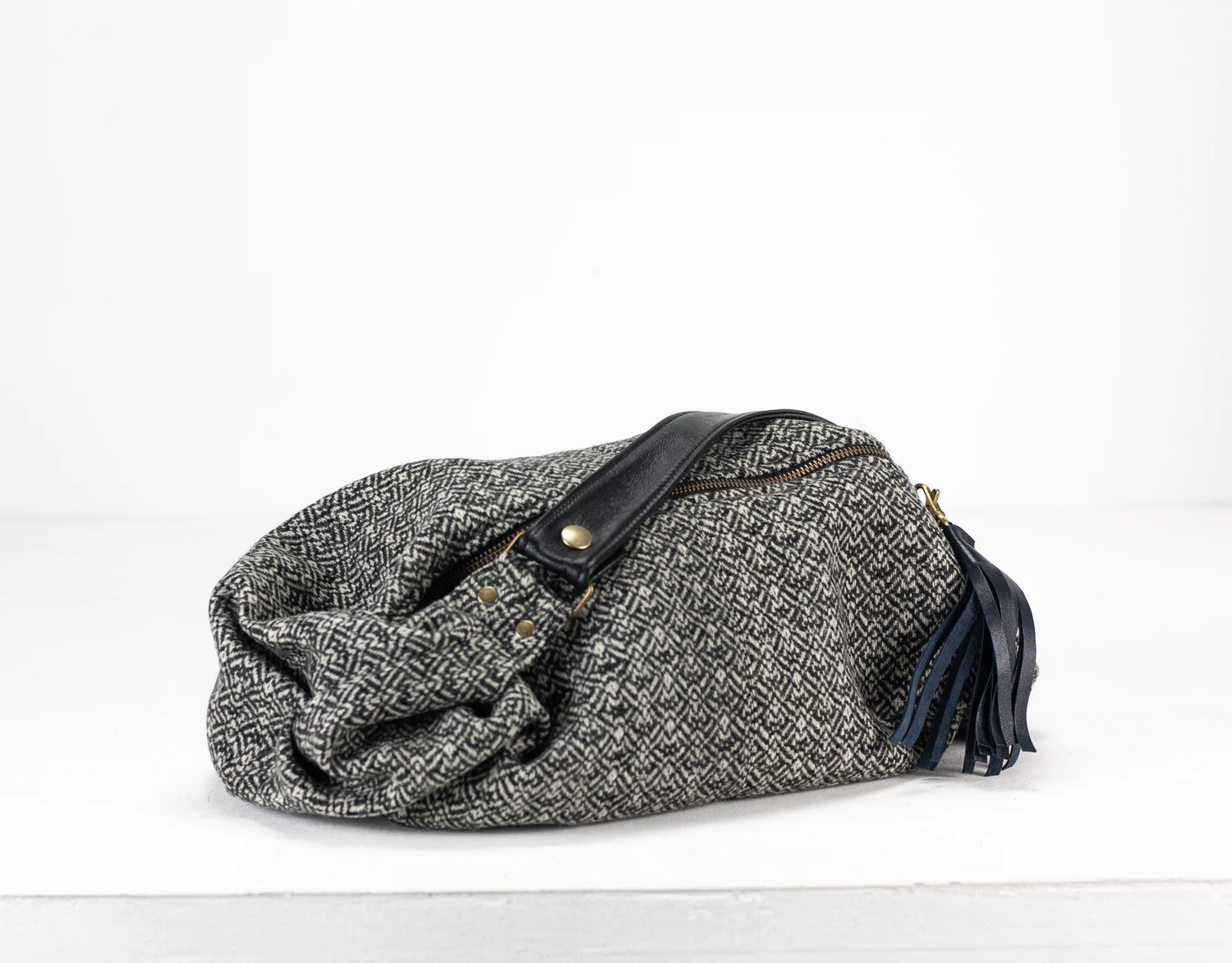 Gray textured bag with black accents on a white background