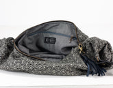 Gray woven bag with a zipper on a white background