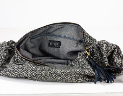 Gray woven bag with a zipper on a white background