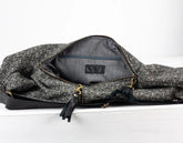 Gray patterned bag with a visible brand logo on a white background