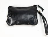 Black leather wristlet clutch with a zipper closure and wrist strap, photographed on a plain white background.