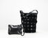 A black leather shoulder bag with a distinctive textured honeycomb pattern and a matching small black leather wristlet pouch, displayed on a clean white background.