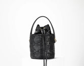 Black quilted handbag on a white background